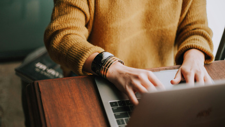 woman typing on a laptop