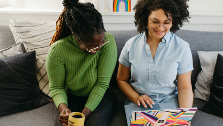 two black women watching on laptop