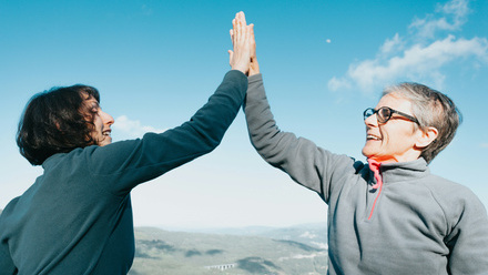 two women celebrating with a high five