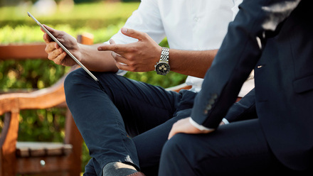 men discussing on bench