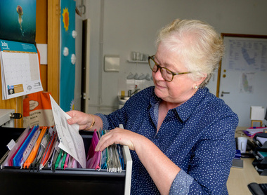 older women looking through filing cabinet