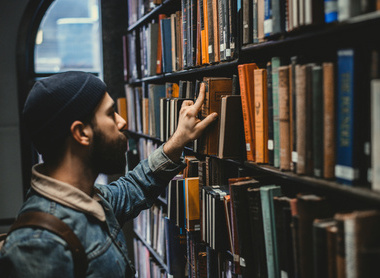 resource library man picking a book